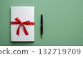 White notebook gift with red ribbon and pen 132719709