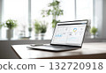 Laptop displaying a data dashboard with charts and metrics sits on office desk by bright window. Business analysis, modern workplace, technology integration 132720918