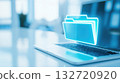 Glowing blue digital folder icon hovers above a laptop keyboard. Data storage, document management, digital technology 132720920