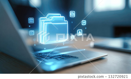 Glowing blue digital folder icon with surrounding file icons hovers over a laptop, representing secure cloud storage, data management and electronic archiving 132720921
