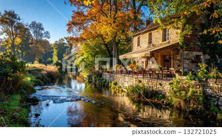House along a stream on an autumn morning 132721025