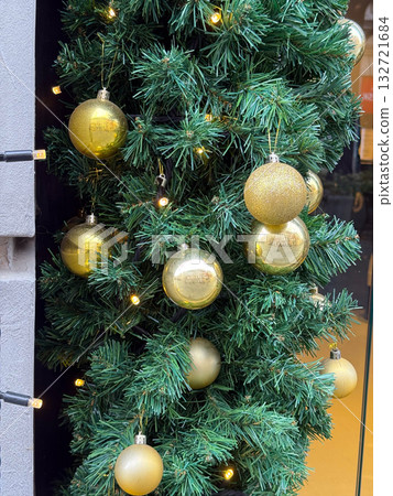 Christmas golden ornaments and lights. Celebration, holiday spirit, and festive decoration bringing warmth and seasonal joy. 132721684
