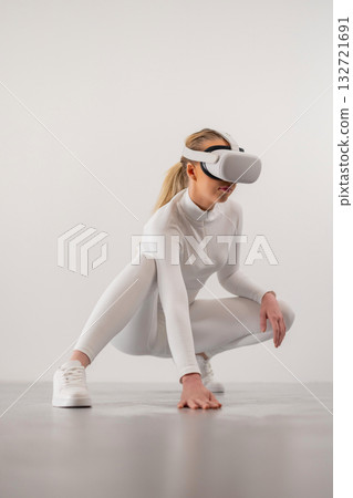 Woman Squatting with Virtual Reality Device 132721691