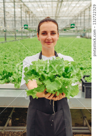 Ladies display fresh vegetable bounty, Female agricultural worker exhibits vibrant leafy greens, Female cultivators showcase their colorful assortment of healthy vegetables with confidence and pride Ladies display fresh vegetable bounty, Female agricultural worker exhibits vibrant leafy greens, Female cultivators showcase their colorful assortment of healthy vegetables with confidence and pride 132722329