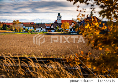 Church In Gilching, Bavaria: Picturesque Autumn Village Landscape With Colorful Trees, Golden Fields, And Dramatic Sky Near Munich 132722519