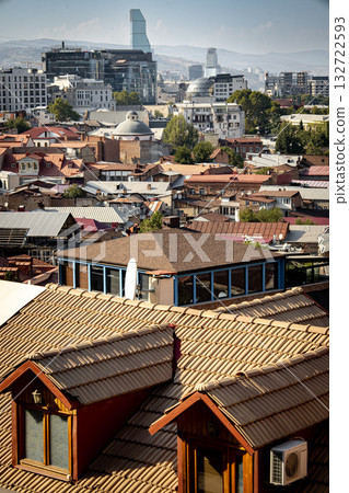 Contrast Of Old And Modern Architecture In Tbilisi Georgia: Traditional Rooftops Of The Historic District With Contemporary Skyscrapers In The Background Under Clear Sky 132722593