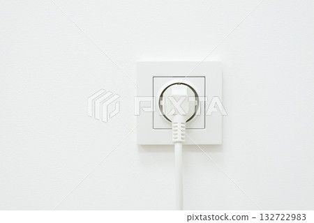 Electric plug of some electronic device in outlet. Concept of electrical outlet, using electricity Electric plug of some electronic device in outlet. Concept of electrical outlet, using electricity 132722983