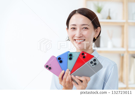 A woman with multiple smartphones A woman with multiple smartphones 132723011