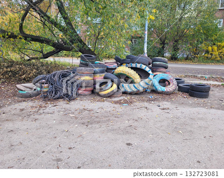 Under the tree is a landfill of old car tires for recycling. Disposal of used tires Under the tree is a landfill of old car tires for recycling. Disposal of used tires 132723081