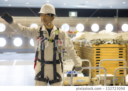 Worker wearing a full harness Worker wearing a full harness 132723098