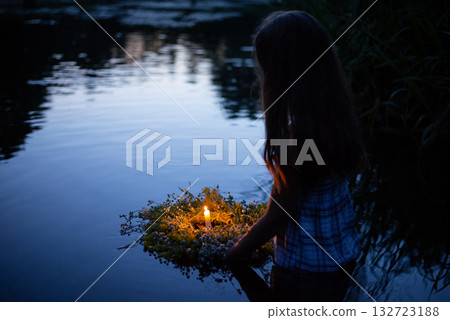 Young girl with wreath on the river on Ivana Kupala night. Ukrainian girl following old slavic traditions 132723188