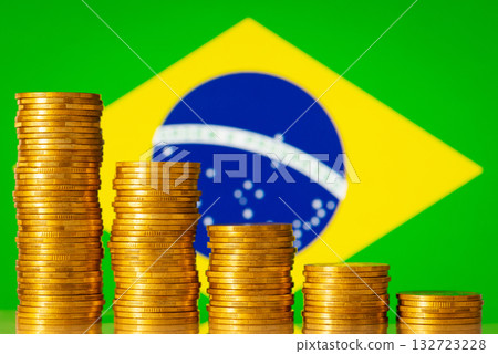 Stacks of coins forming negative graph against flag of Brazil. Concept of economic regression, crisis in country Stacks of coins forming negative graph against flag of Brazil. Concept of economic regression, crisis in country 132723228