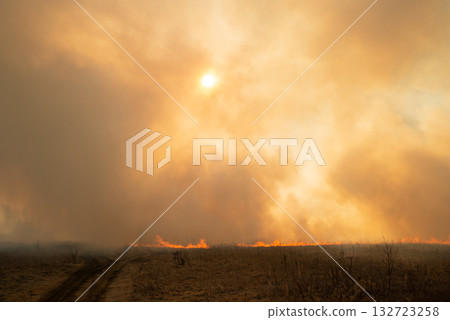 Clouds of smoke because of forest and field fire. Dangerous fire spreading through dry grass Clouds of smoke because of forest and field fire. Dangerous fire spreading through dry grass 132723258