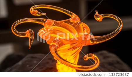 Molten orange glass sculpture twisting in elegant flowing shapes. Molten orange glass sculpture twisting in elegant flowing shapes. 132723687
