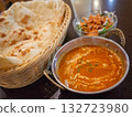[Japan] Butter chicken curry, naan, and salad lined up on a table at an Indian restaurant 132723980