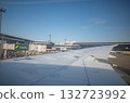 [Japan] View of the airplane wing, runway and clear blue sky from a window seat before takeoff at Haneda Airport 132723992