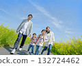 Four people walking on the promenade of rape blossoms 132724462