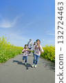 Four people walking on the promenade of rape blossoms 132724463