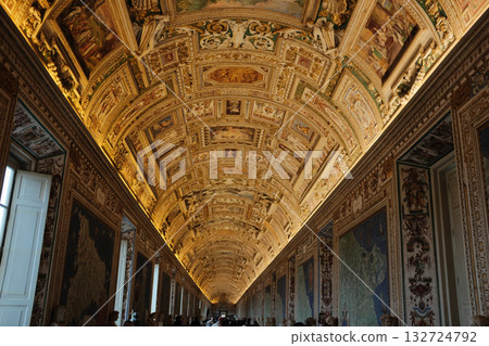Long ornate gallery corridor with gilded vaulted ceiling crowds of visitors perspective lines Vatican Museums Rome Italy. High quality photo Long ornate gallery corridor with gilded vaulted ceiling crowds of visitors perspective lines Vatican Museums Rome Italy. High quality photo 132724792