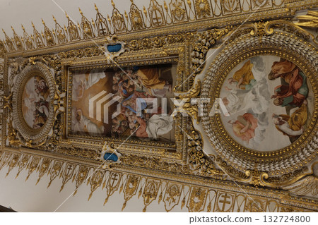 Gilded ceiling panel with roundel and framed paintings pearls and floral reliefs intricate renaissance decoration Vatican Museums close up. High quality photo 132724800