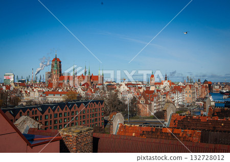 Beautiful sunset over the old town of Gdansk with City Hall and St. Mary Basilica, Poland. High quality photo 132728012