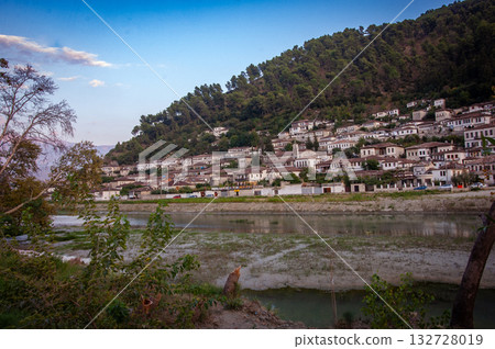 Sunset over the town of Berat on the Osum River, known for its white Ottoman houses. Also called the 'City of a Thousand Windows,' it is built against the hillside below the citadel. 132728019
