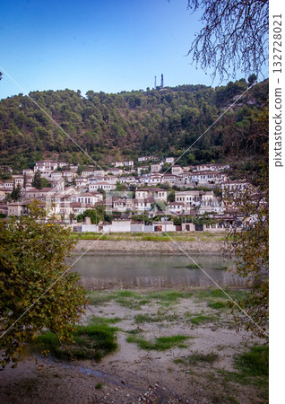 Sunset over the town of Berat on the Osum River, known for its white Ottoman houses. Also called the 'City of a Thousand Windows,' it is built against the hillside below the citadel. Sunset over the town of Berat on the Osum River, known for its white Ottoman houses. Also called the 'City of a Thousand Windows,' it is built against the hillside below the citadel. 132728021