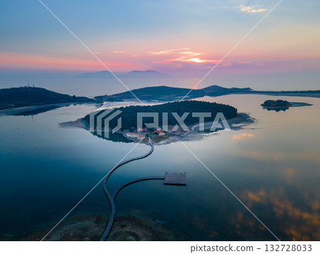 Aerial landscape photography. Fantastic morning view of St Mary's Monastery and wooden pier. Magnificent spring seascape of Narta Lagoon. Beautiful outdoor scene of Albania, Europe. Aerial landscape photography. Fantastic morning view of St Mary's Monastery and wooden pier. Magnificent spring seascape of Narta Lagoon. Beautiful outdoor scene of Albania, Europe. 132728033