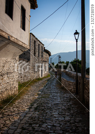 Sunset over the town of Berat on the Osum River, known for its white Ottoman houses. Also called the 'City of a Thousand Windows,' it is built against the hillside below the citadel. 132728059