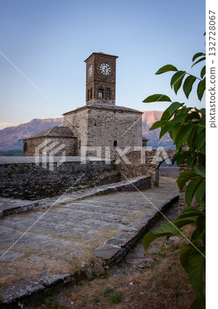 Sunset over clock tower and fortress at Gjirokaster, a beautiful town in Albania where the Ottoman legacy is clearly visible. High above the town the huge castle offers panoramic views. 132728067