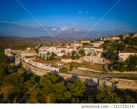 Aerial view of the old Castle of Berat and its ancient neighborhoods in sunset light, located in Albania. Photo taken with drone Aerial view of the old Castle of Berat and its ancient neighborhoods in sunset light, located in Albania. Photo taken with drone 132728114