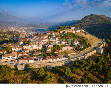 Aerial view of the old Castle of Berat and its ancient neighborhoods in sunset light, located in Albania. Photo taken with drone Aerial view of the old Castle of Berat and its ancient neighborhoods in sunset light, located in Albania. Photo taken with drone 132728121