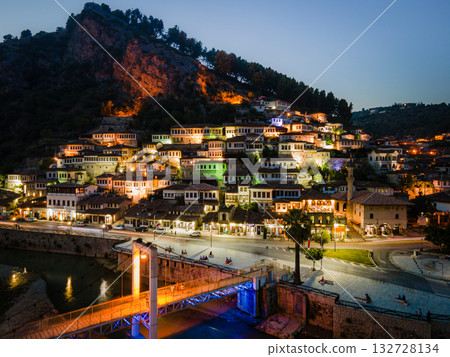 Sunset over the town of Berat on the Osum River, known for its white Ottoman houses. Also called the 'City of a Thousand Windows,' it is built against the hillside below the citadel. Sunset over the town of Berat on the Osum River, known for its white Ottoman houses. Also called the 'City of a Thousand Windows,' it is built against the hillside below the citadel. 132728134