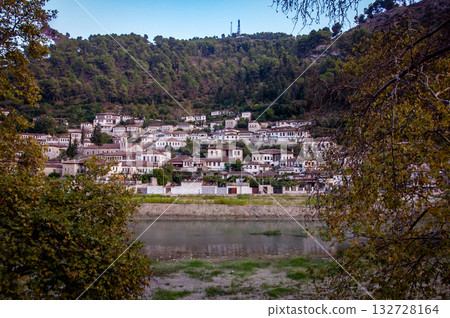 Sunset over the town of Berat on the Osum River, known for its white Ottoman houses. Also called the 'City of a Thousand Windows,' it is built against the hillside below the citadel. 132728164