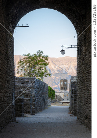 Sunset over clock tower and fortress at Gjirokaster, a beautiful town in Albania where the Ottoman legacy is clearly visible. High above the town the huge castle offers panoramic views. Sunset over clock tower and fortress at Gjirokaster, a beautiful town in Albania where the Ottoman legacy is clearly visible. High above the town the huge castle offers panoramic views. 132728169