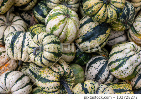 Close-up pile of pumpkins Fresh orange pumpkins stacked tightly, perfect seasonal harvest background for autumn and Halloween. 132728272