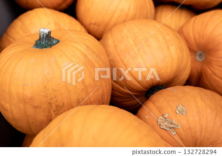 Close-up pile of pumpkins Fresh orange pumpkins stacked tightly, perfect seasonal harvest background for autumn and Halloween. 132728294
