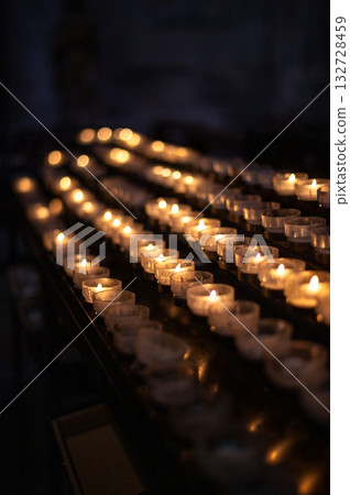 A serene scene of glowing candles inside Cologne Cathedral, Germany. A serene scene of glowing candles inside Cologne Cathedral, Germany. 132728459