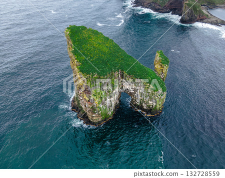 Close-up shot of famous Drangarnir cliff with Tindholmur islands in the background taken during early morning hike in spring at Faroese coastline Faroe Island, Denmark, Europe. High quality photo Close-up shot of famous Drangarnir cliff with Tindholmur islands in the background taken during early morning hike in spring at Faroese coastline Faroe Island, Denmark, Europe. High quality photo 132728559