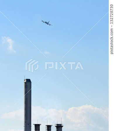A Self-Defense Force patrol aircraft flies over the four chimneys of the industrial park. 132728730