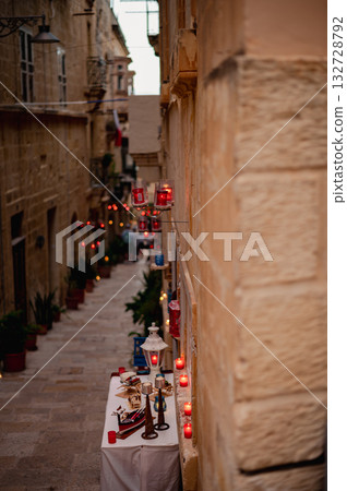 Numerous candles glow on the ancient walls of Birgu during the Birgu by Candlelight festival, creating a warm and magical ambiance 132728792