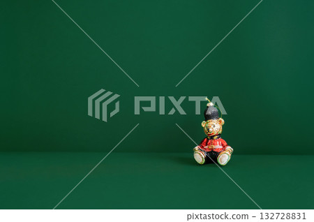 Festive dark green Christmas background decorated with ornaments, baubles, and holiday lights, creating a cozy seasonal atmosphere. Festive dark green Christmas background decorated with ornaments, baubles, and holiday lights, creating a cozy seasonal atmosphere. 132728831