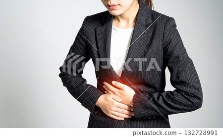 A woman holding her stomach with stomachache A woman holding her stomach with stomachache 132728991