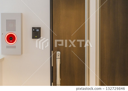 Entrance door, fire alarm and intercom of an apartment building Entrance door, fire alarm and intercom of an apartment building 132729846