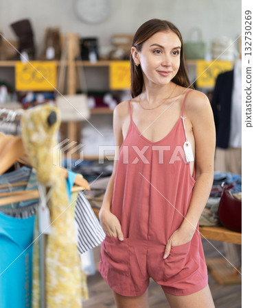 Young woman in cotton overalls in shop 132730269