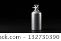 Brushed aluminum gas cylinder with brass fitting against a stark black background 132730390