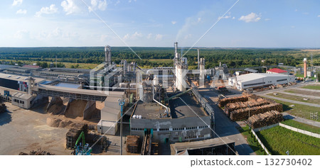 Aerial view of wood processing factory with stacks of lumber at plant manufacturing yard. Aerial view of wood processing factory with stacks of lumber at plant manufacturing yard. 132730402