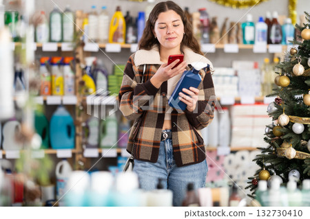 Young woman scanning qr code for cleaning spray 132730410