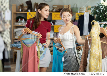 Young women choose summer dresses 132730417