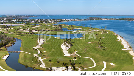 Aerial view of large golf field with green grass in Boca Grande, small town on Gasparilla Island in southwest Florida. Outdoor activities for wealthy people Aerial view of large golf field with green grass in Boca Grande, small town on Gasparilla Island in southwest Florida. Outdoor activities for wealthy people 132730520